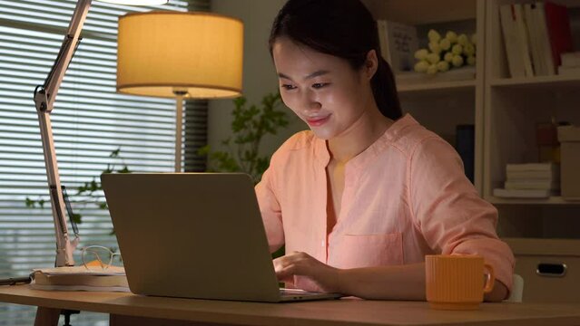 Young Asian businesswoman working late at midnight