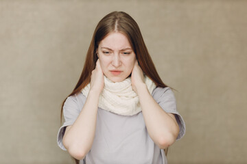 Young woman wearing scarf holds head flu catarrh ill sick disease treatment cold - 767208846