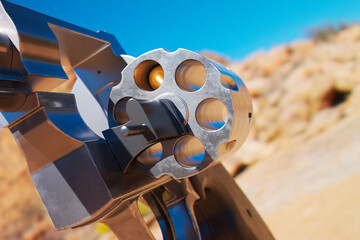 Intricate Close-up of Empty Revolver Cylinder in Arid Desert Landscape
