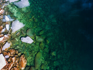 Melting ice floes in the blue water of Baikal lake in spring. Baikal lake, Siberia, Russia.