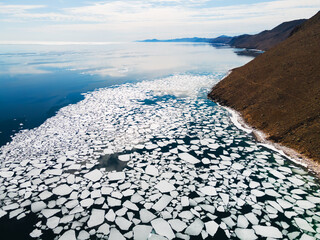Melting ice floes on the shore of Baikal lake in spring. Olkhon island, Baikal lake, Siberia, Russia
