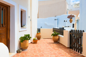 Cycladic architecture in Santorini island, Greece. Cozy courtyard with flowers.