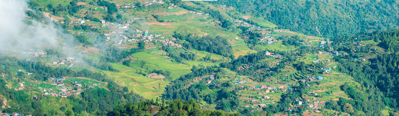 Aerial view of some Nepalese villages surrounded by nature and rice fields in the valleys at the foot of the Himalayan mountain range, seen from Nagarkot. Nepal