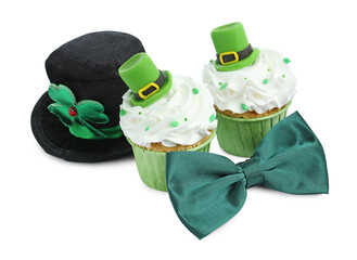 St. Patrick's day party. Tasty festively decorated cupcakes, green bow tie and leprechaun hat,...