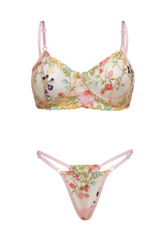 Close-up shot of a pink lingerie set consisting of an embroidered bra and embroidered thong panties string. Women's transparent mesh lingerie is isolated on a white background. Front view.