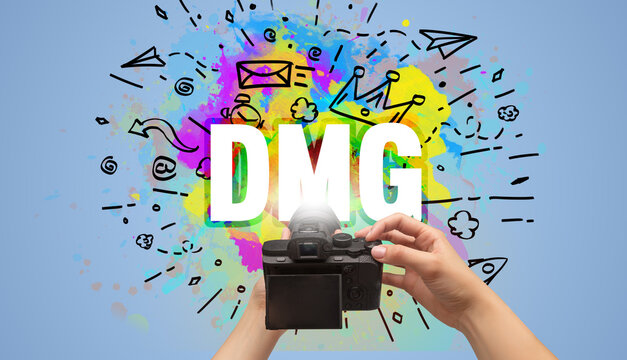 Close-up of a hand holding digital camera with abstract drawing