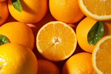 Tasty ripe fresh oranges and leaves as background, top view