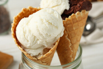 Ice cream scoops in wafer cones on table, closeup