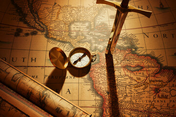 Illuminated Vintage World Map, Brass Compass, and Magnifying Glass on Desk
