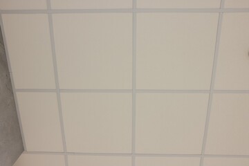 White ceiling with PVC tiles, view from below