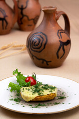 Baked potatoes with cheese and herbs on a plate and with wine
