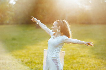 Fototapeta na wymiar smiling elegant woman in white shirt in meadow outdoors