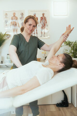 Fototapeta na wymiar happy female massage therapist in massage cabinet doing checkup