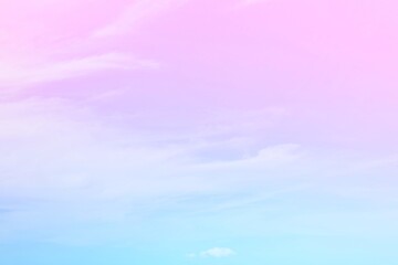 The delicacy of the soft white clouds  On a background of a faded sky with gradients of pink,...