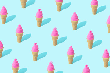 Trendy sunlight summer pattern made with pink ice cream on bright light blue background. Minimal summer concept.