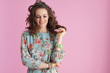 smiling modern woman in floral dress on pink