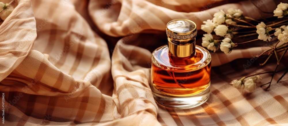 Poster a liquid perfume is displayed in a glass bottle on a table alongside a bouquet of flowers, creating 