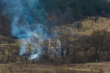 agricultural waste bonfires from dry grass and straw stubble burning with thick smoke polluting air during dry season causing global warming and carcinogen fumes