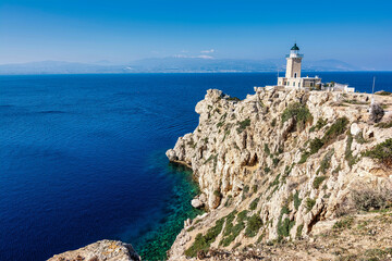 Fototapeta na wymiar Melagkavi Lighthouse also known as Cape Ireon Light on a headland overlooking the eastern Gulf of Corinth, Greece