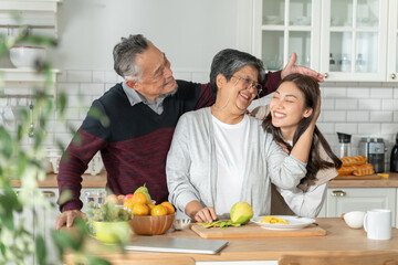 young daughter look to old mother cook in kitchen.Beautiful female enjoy spend leisure time and...