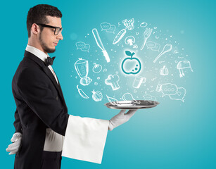 Waiter holding silver tray with food icons above - 767231294