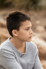 Portrait of confident preteen boy sitting outside, childhood memories and Middle School age concept
