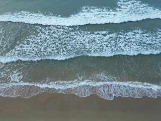 Aerial view drone over beach with  turquoise water and waves