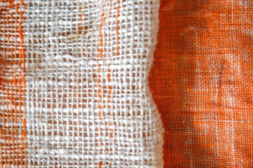 Abstract orange and white textured cloth or textile material, full frame background photo