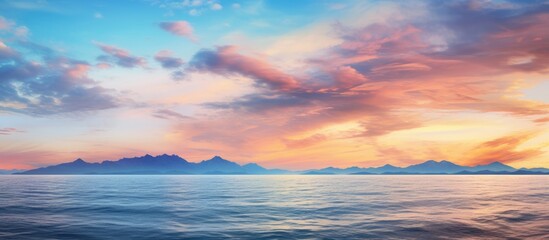 A beautiful sunset over the ocean with mountains