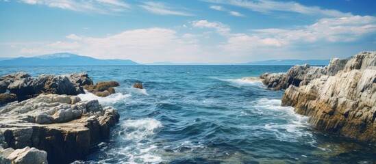 Fototapeta na wymiar A rocky seashore with waves crashing on the rocks
