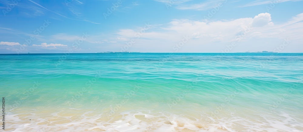 Sticker Aerial view of a beach under a clear blue sky