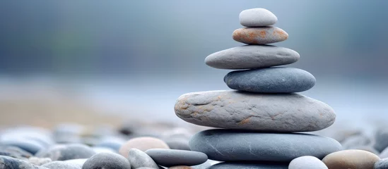  A close-up of a stack of stones on a seashore © Ilgun