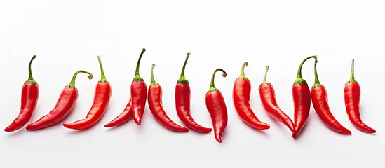 Tuinposter Red hot chili peppers in a row © Ilgun