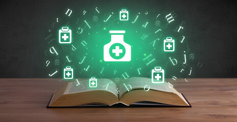 Open medical book with health icons above - 767242088