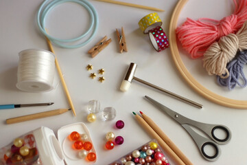 Various craft supplies on white background. Supplies for jewelry making, drawing and needlework. Selective focus.