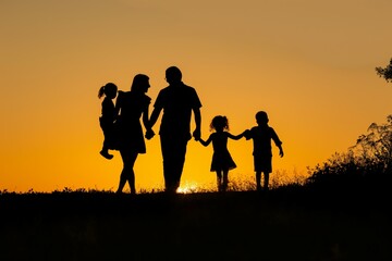 Silhouette of family with children at sunset