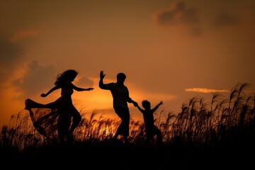 Fototapeta premium Family of silhouettes against sunset sky