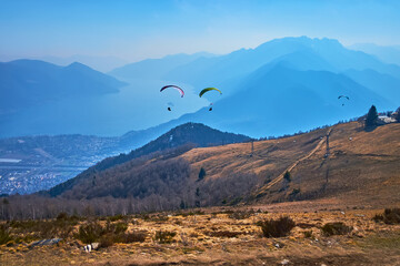 The glider aircrafts over Cimetta Mountain slope, Ticino, Switzerland