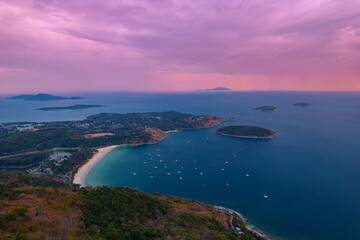 Aerial view Sunset landscape Nai Harn beach and marina with white yachts, Rawai resort with windmill, travel paradise blue sea of Phuket, Thailand