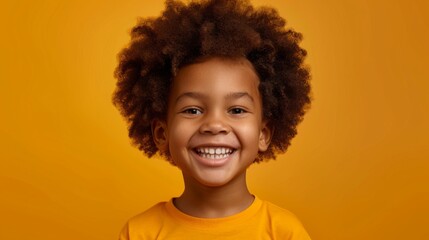 The smile of an African American elementary school boy. Portrait of smiling kid with white teeth on 