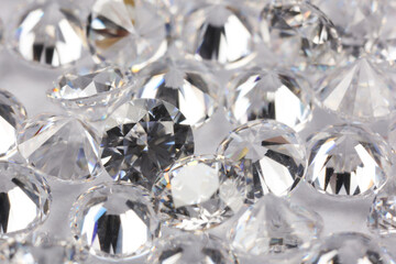 Many beautiful shiny diamonds on light background, closeup