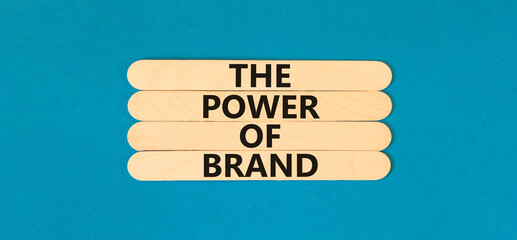 The power of brand symbol. Concept words The power of brand on wooden stick. Beautiful blue table...