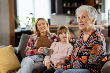 Generational bonding, grandmother, daughter, and grandchild sharing stories on a cozy afternoon