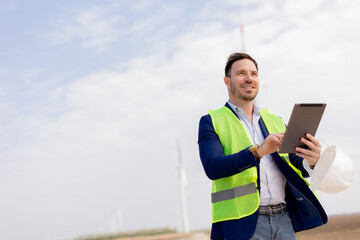 Confident Engineer Overseeing Renewable Energy Project at Wind Farm © BGStock72