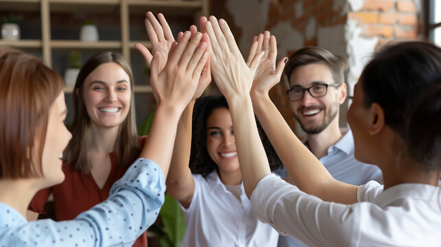 Team Unity, Celebrating Success. A group of people giving each other a high five, symbolizing teamwork and achievement. The image captures a moment of celebration and unity among colleagues or friends