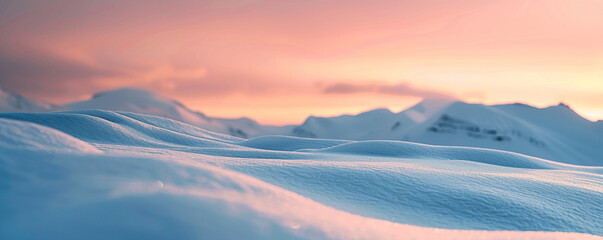 A snow-covered mountain range during sunset, the sky