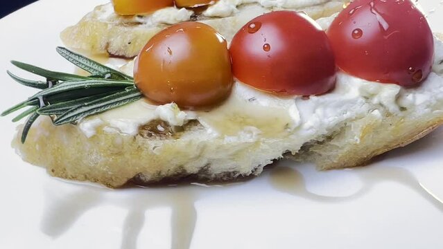 Sandwiches with cottage cheese and cucumber slices, cherry tomatoes on a white farm baguette on a wooden table. Close-up shooting.