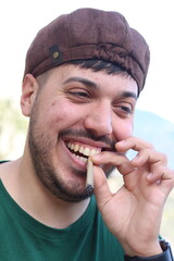 High Spirits: Guy Laughs with Legalized Joint in Mouth