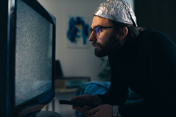 Man in Tin Foil Hat and Blanket Watching TV Interference