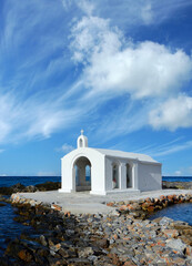 Small white church in sea near Georgioupolis town on Crete, Greece